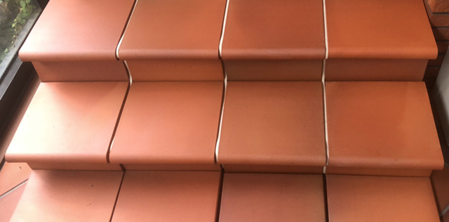 LOPO offers matching 330x330 mm terracotta high-fired floor tiles that seamlessly align with the bullnose tiles, creating a cohesive design for staircases and adjacent flooring areas.