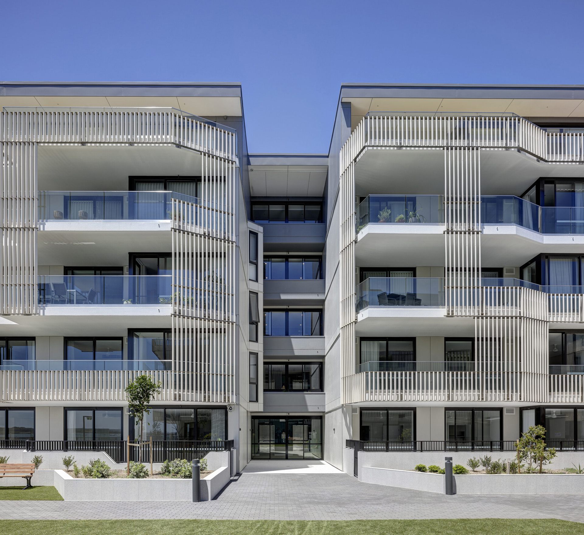 A striking exterior shot of Anglicare Woolooware Shores, featuring the seamless integration of Terracotta Louvers into the modern architectural design. The facade demonstrates the perfect balance of functionality, sustainability, and elegance.